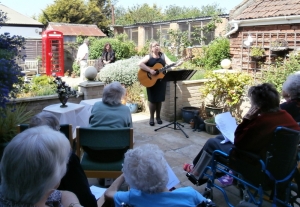 Carol plays her guitar