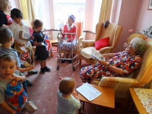 The children visit the residents in the lounge