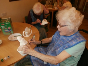 Margaret painting her gnome