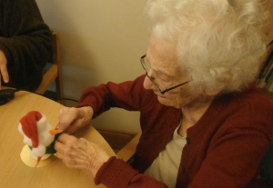 Kathy adds a scarf to her snowman