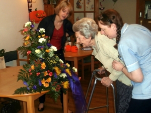 Joan admires the arrangement