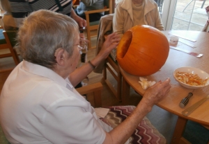 Joyce hollows out a pumpkin