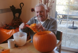 Wally hollowing out a pumpkin
