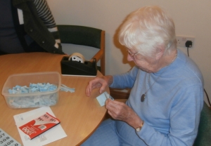 Jean helps fold sold raffle tickets ready for the day