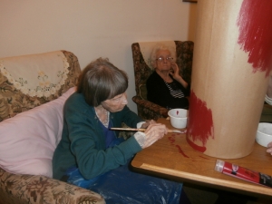 Tilly busy painting the postbox